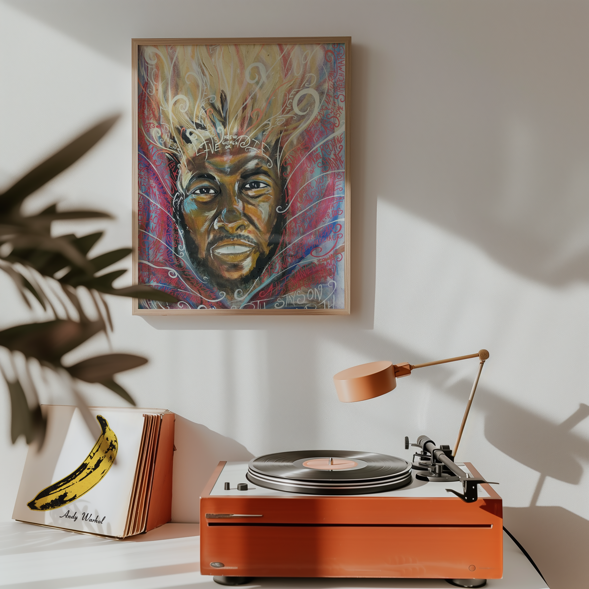 Medium lyric art print hanging above a record player