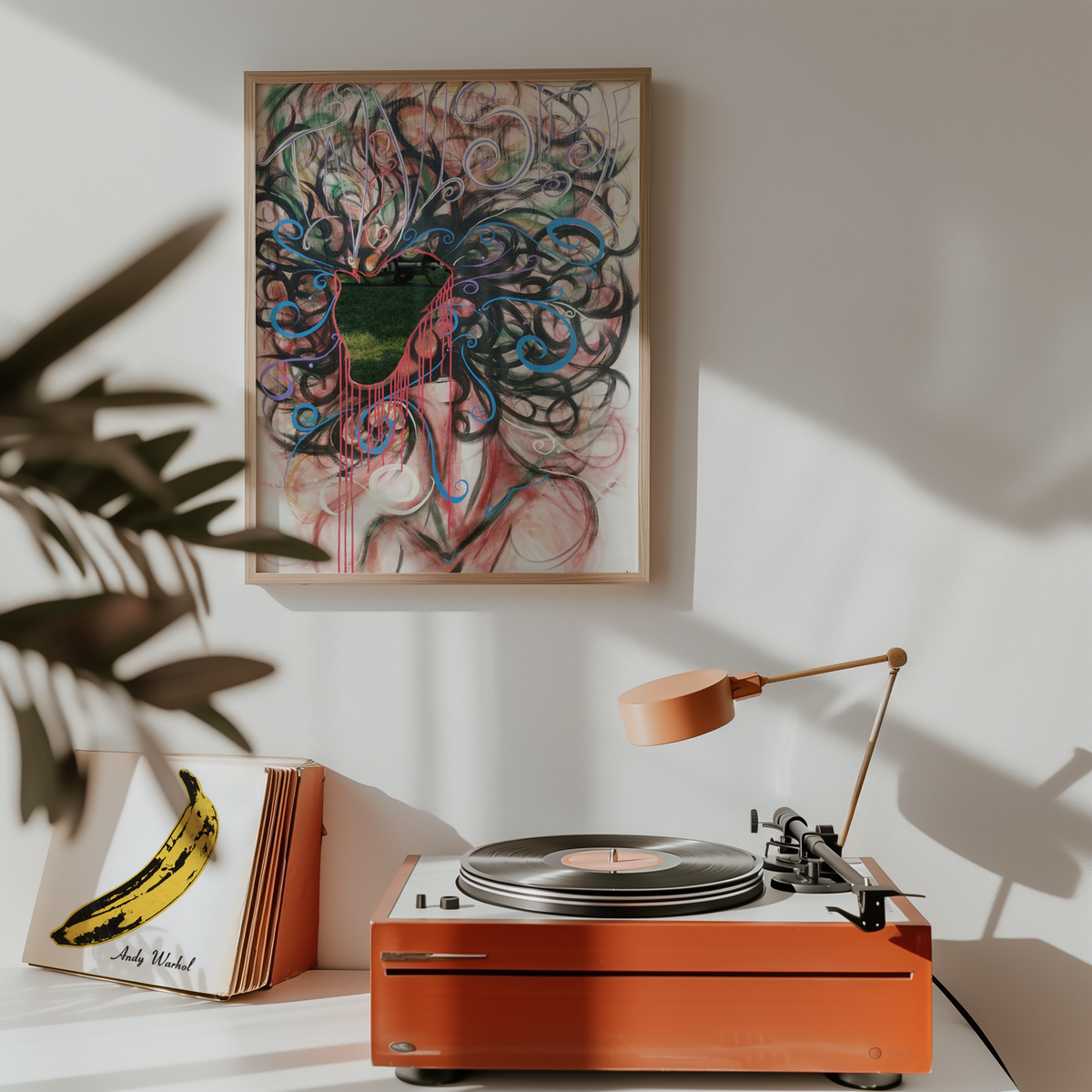 Medium African American art print hanging above a record player